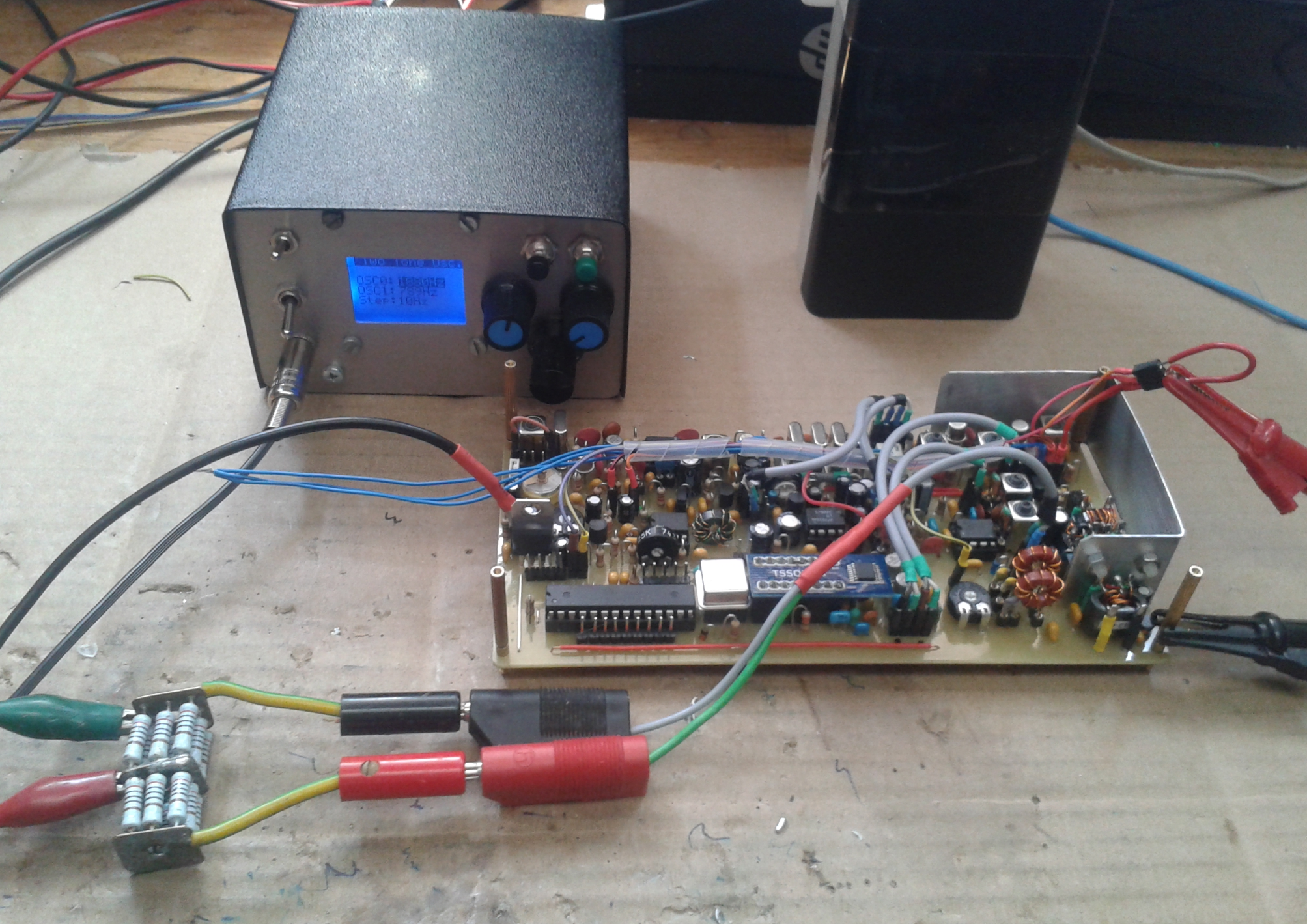 Transmitter test setup: Left background: Digital version of Two-Tone-Generator. Front: Dummy load with voltage divider 2:1. Right: Power supply connecting +12V perm. and +12V TX.